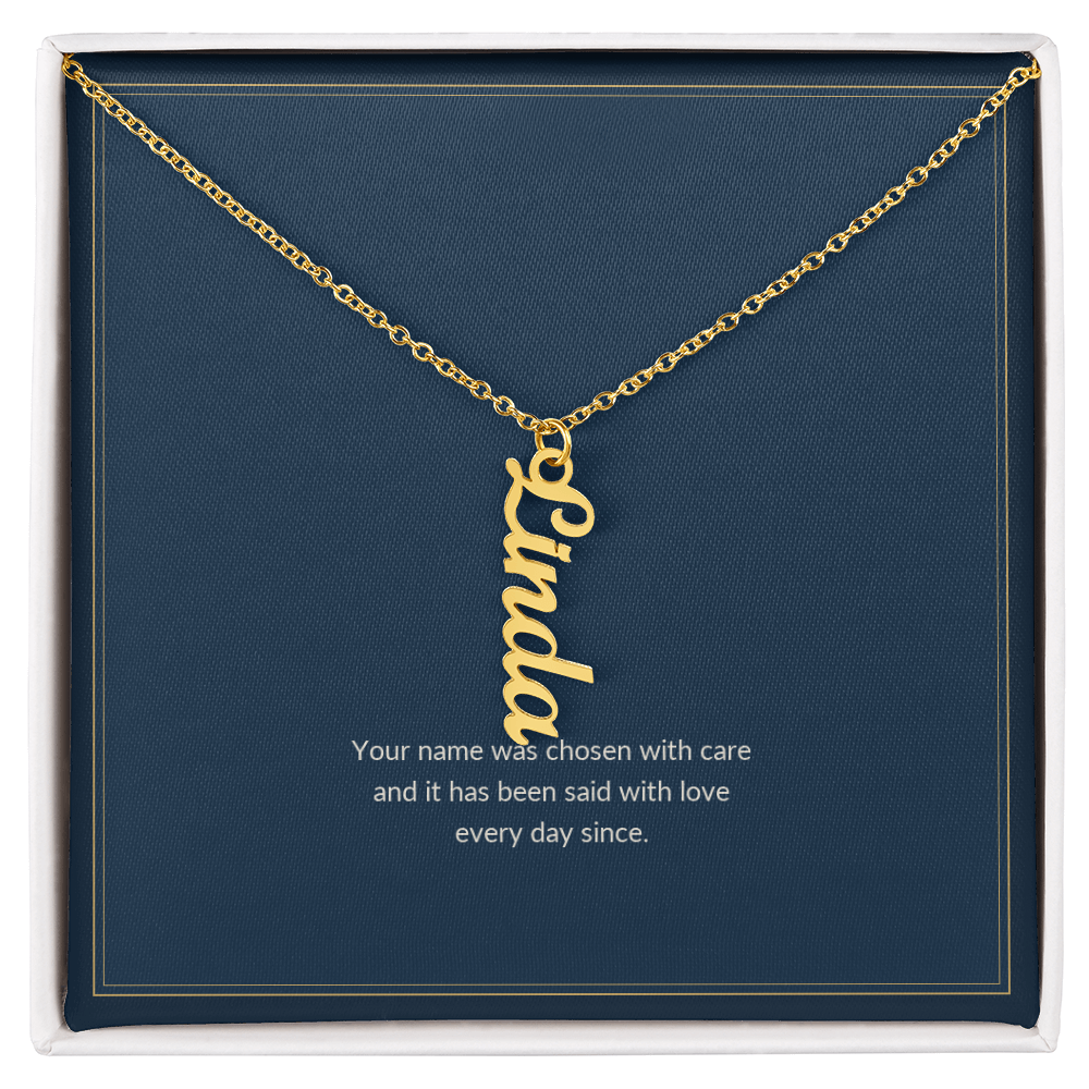 Vertical Name necklace, 18k yellow gold, on a keepsake card for Granddaughter, in a standard gift box (view 1)