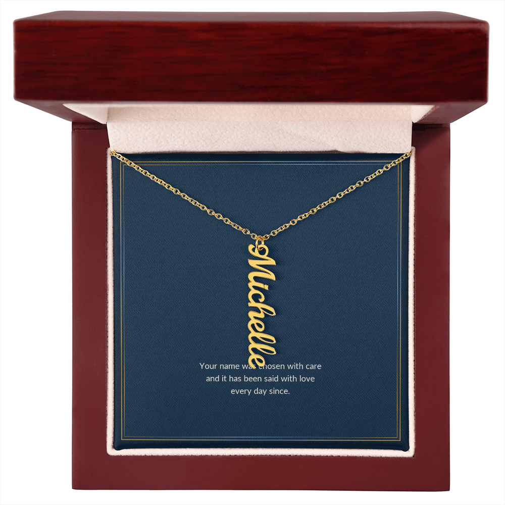 Vertical Name necklace, 18k yellow gold, on a keepsake card for Granddaughter, in a luxury wooden box (view 1)