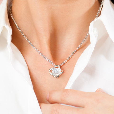 Love Knot necklace worn with a white blouse